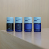 The four Skin at Peace bottles in a row: Clean, Tone, Day, and Night, with light blue caps.