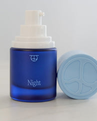 Night, bakuchiol serum + moisturizer, with its cap off.