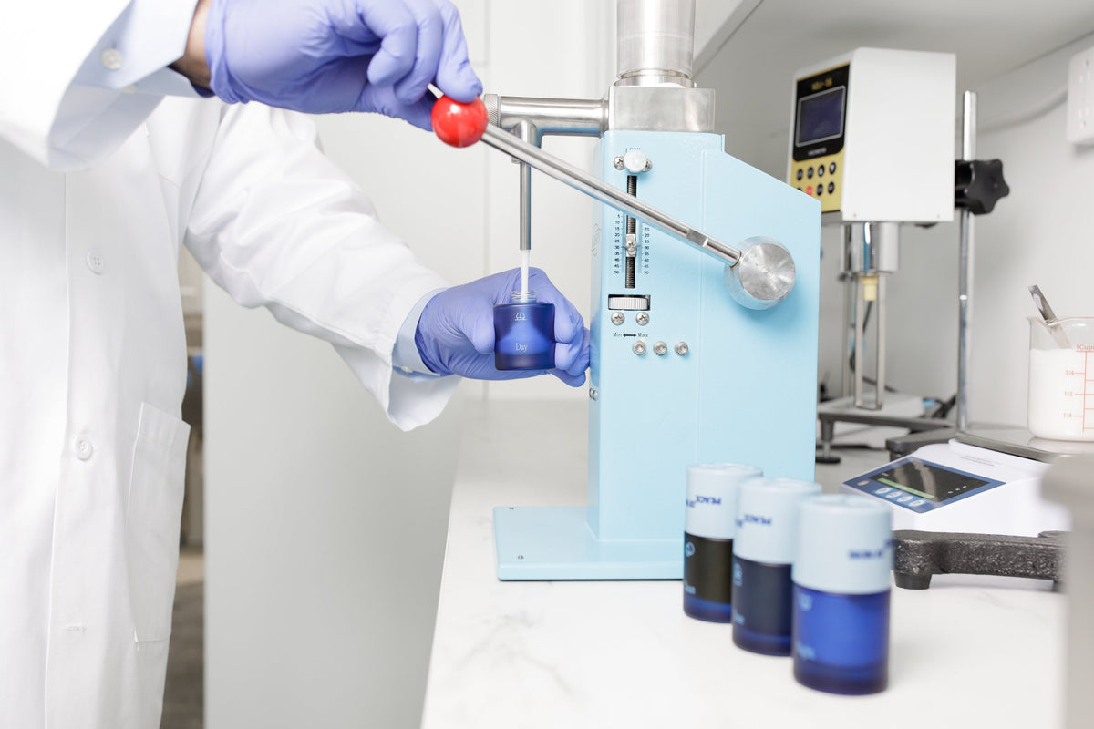 Skin At Peace, filling a bottle in the lab