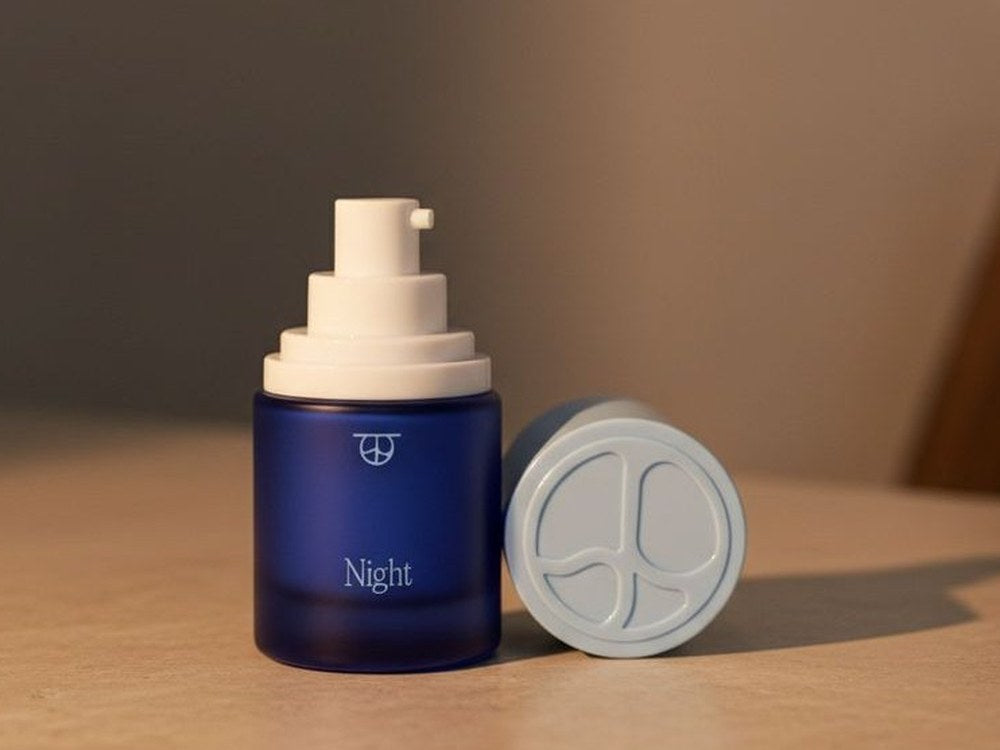 Night on a table in warm light, its cap beside it.